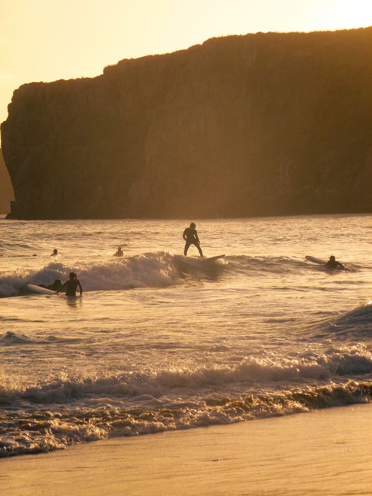 Surfers at sunset on an Algarve beach